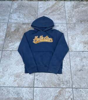 Hollister Navy Blue Pullover Hoodie with Embroidered Script Logo